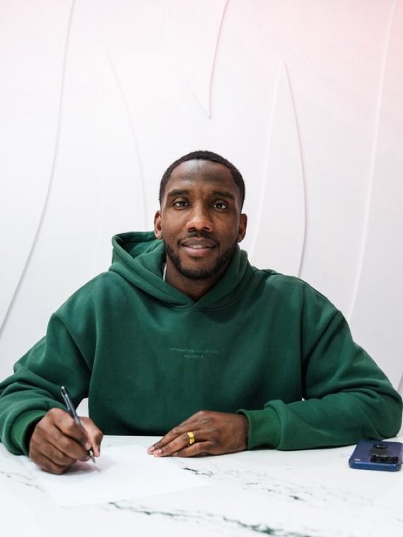 Josh Johnson signing a contract.