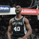 A close-up vertical shot of San Antonio Spurs player Harrison Barnes. He is wearing a black "Icon Edition" jersey with "SPURS" and his number "40" in white.