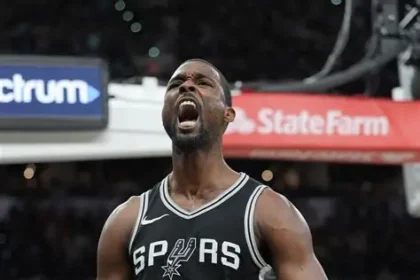 A close-up vertical shot of San Antonio Spurs player Harrison Barnes. He is wearing a black "Icon Edition" jersey with "SPURS" and his number "40" in white.