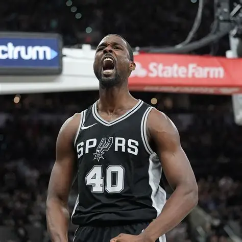 A close-up vertical shot of San Antonio Spurs player Harrison Barnes. He is wearing a black "Icon Edition" jersey with "SPURS" and his number "40" in white.