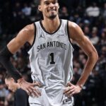 Victor Wembanyama standing triumphant, after defeating the Rockets