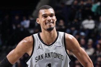 Victor Wembanyama standing triumphant, after defeating the Rockets