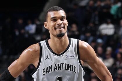 Victor Wembanyama standing triumphant, after defeating the Rockets