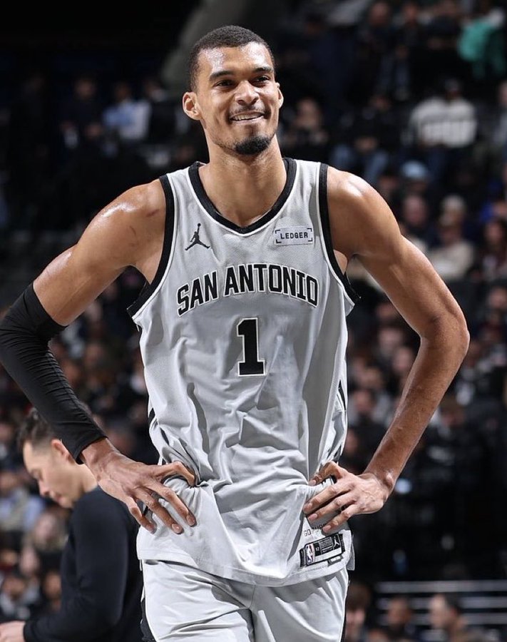 Victor Wembanyama standing triumphant, after defeating the Rockets