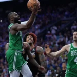 Boston Celtics’ Jaylen Brown, left, goes up for a shot past Philadelphia 76ers’ Kelly Oubre Jr. during the first half of Game 3 in a first-round NBA playoffs basketball series Friday, April 24, 2026, in Philadelphia. (AP Photo/Matt Slocum)