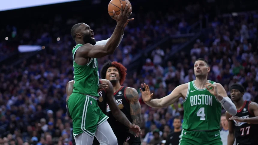 Boston Celtics’ Jaylen Brown, left, goes up for a shot past Philadelphia 76ers’ Kelly Oubre Jr. during the first half of Game 3 in a first-round NBA playoffs basketball series Friday, April 24, 2026, in Philadelphia. (AP Photo/Matt Slocum)