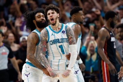 Charlotte Hornets guard LaMelo Ball (1) celebrates with guard Coby White after scoring against the Miami Heat during the second half of an NBA play-in tournament basketball game in Charlotte, N.C., Tuesday, April 14, 2026.