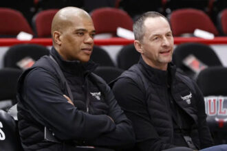 Chicago Bulls executive vice president of basketball operations Arturas Karnisovas (right) talks with general manager Marc Eversley (left) before game three of the first round for the 2022 NBA playoffs against the Milwaukee Bucks at United Center.