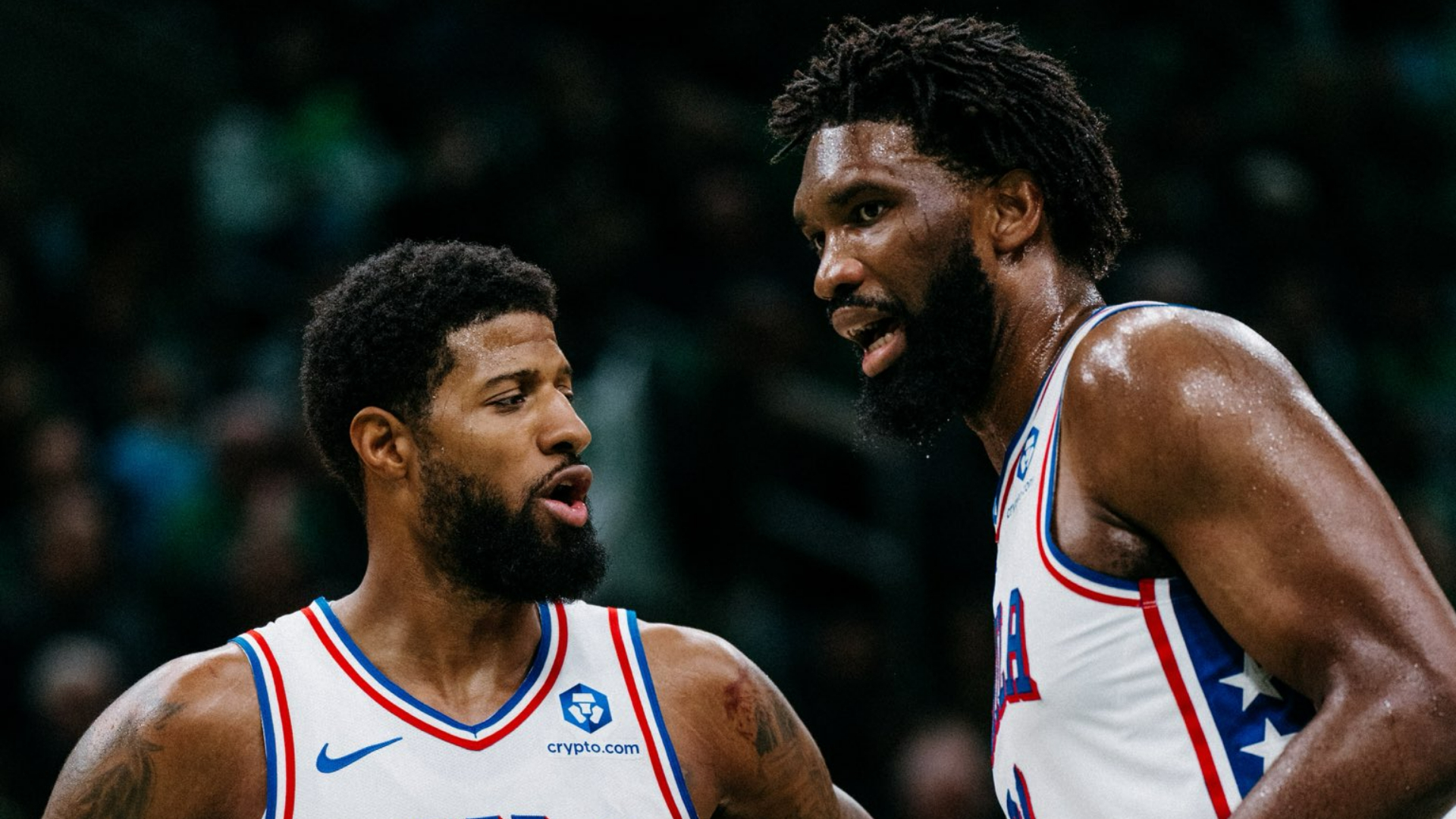 Paul George and Joel Embiid confer during their critical Game 5 victory in Boston.