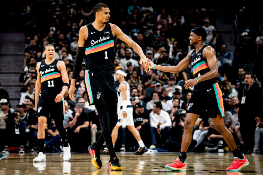 Wembanyama celebrating with fellow players in Spurs win over Mavericks on April 11, 2026