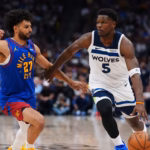 Minnesota Timberwolves guard Anthony Edwards (5) drives to the basket against Denver Nuggets guard Jamal Murray (27) during the second half in Game 2 of a first-round NBA playoffs basketball series Monday, April 20, 2026, in Denver. Credit: AP/Jack Dempsey