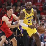 Apr 24, 2026; Houston, Texas, USA; Los Angeles Lakers forward LeBron James (23) controls the ball as Los Angeles Lakers guard Austin Reaves (15) defends during the first quarter during game three of the first round of the 2026 NBA Playoffs at Toyota Center. Mandatory Credit: Troy Taormina-Imagn Images