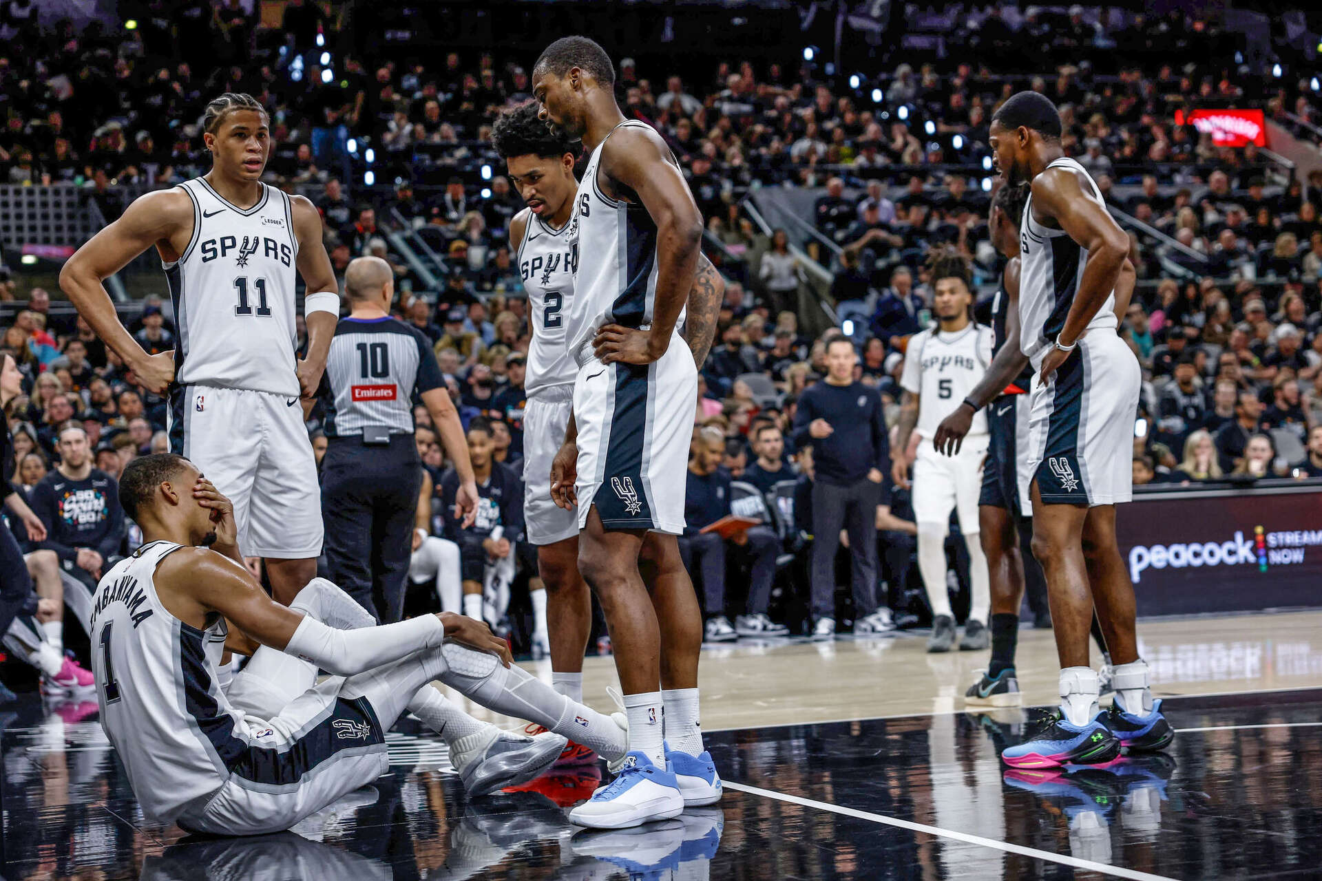 Victor Wembanyama sits on the court after taking a hard fall in the first half against Portland on Tuesday night at Frost Bank Center on Tuesday, April 21, 2026.Sam Owens/San Antonio Express-News