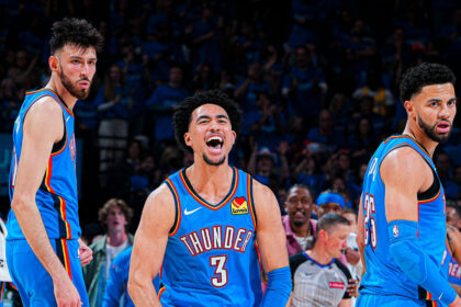 Oklahoma City Thunder players Chet Holmgren, Ajay Mitchell, and Alex Caruso celebrate on the court during their 108-90 Game 1 victory over the Los Angeles Lakers.