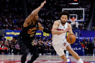 Detroit Pistons PG Cade Cunningham drives to the basket on Cleveland Cavaliers SG Donovan Mitchell in Game 1 of their second-round series of the 2026 NBA Playoffs at Little Caesars Arena in Michigan.
