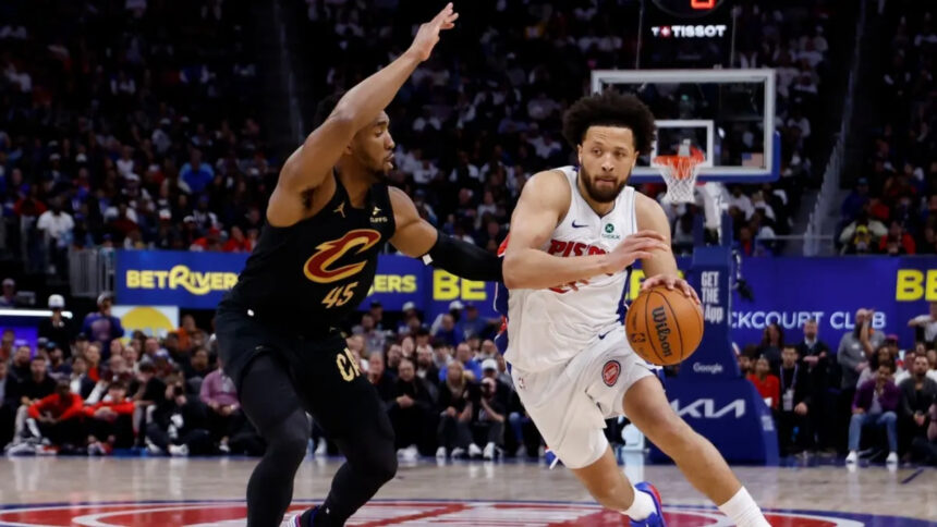 Detroit Pistons PG Cade Cunningham drives to the basket on Cleveland Cavaliers SG Donovan Mitchell in Game 1 of their second-round series of the 2026 NBA Playoffs at Little Caesars Arena in Michigan.