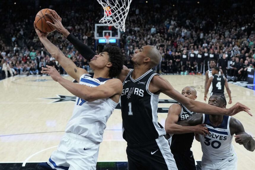 Minnesota Timberwolves forward Joan Beringer (19) is blocked by San Antonio Spurs forward Victor Wembanyama (1) as he drives to the basket during the second half of an NBA basketball game in San Antonio, Saturday, Jan. 17, 2026. Eric Gay/AP