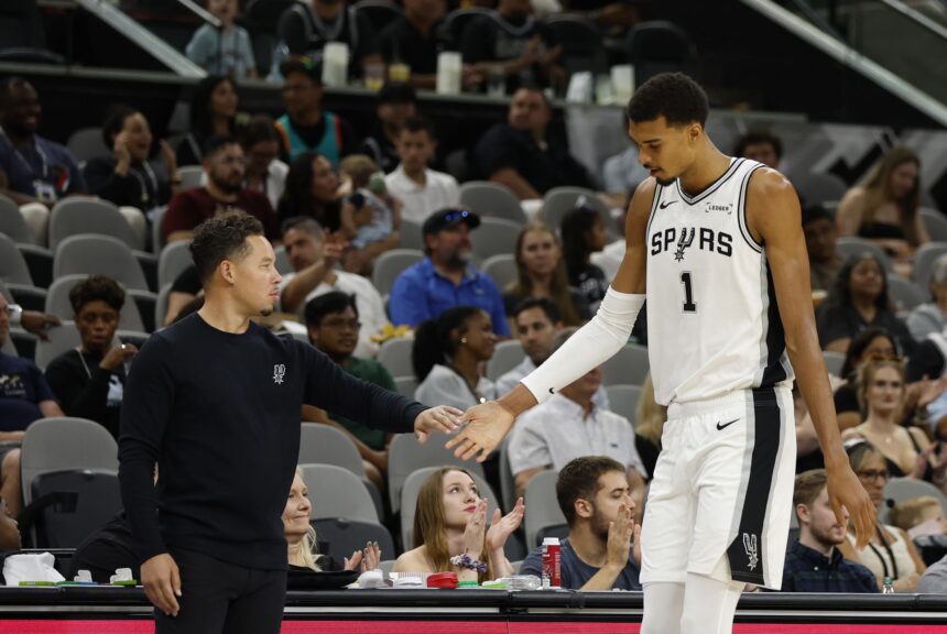 San Antonio Spurs Victor Wembanyama (1) gets congratulation from San Antonio Spurs head coach Mitch Johnson in a Spurs preseason opener vs. Guangzhou Loong-Lions on Monday, Oct. 6, 2025 at Frost Bank Center.