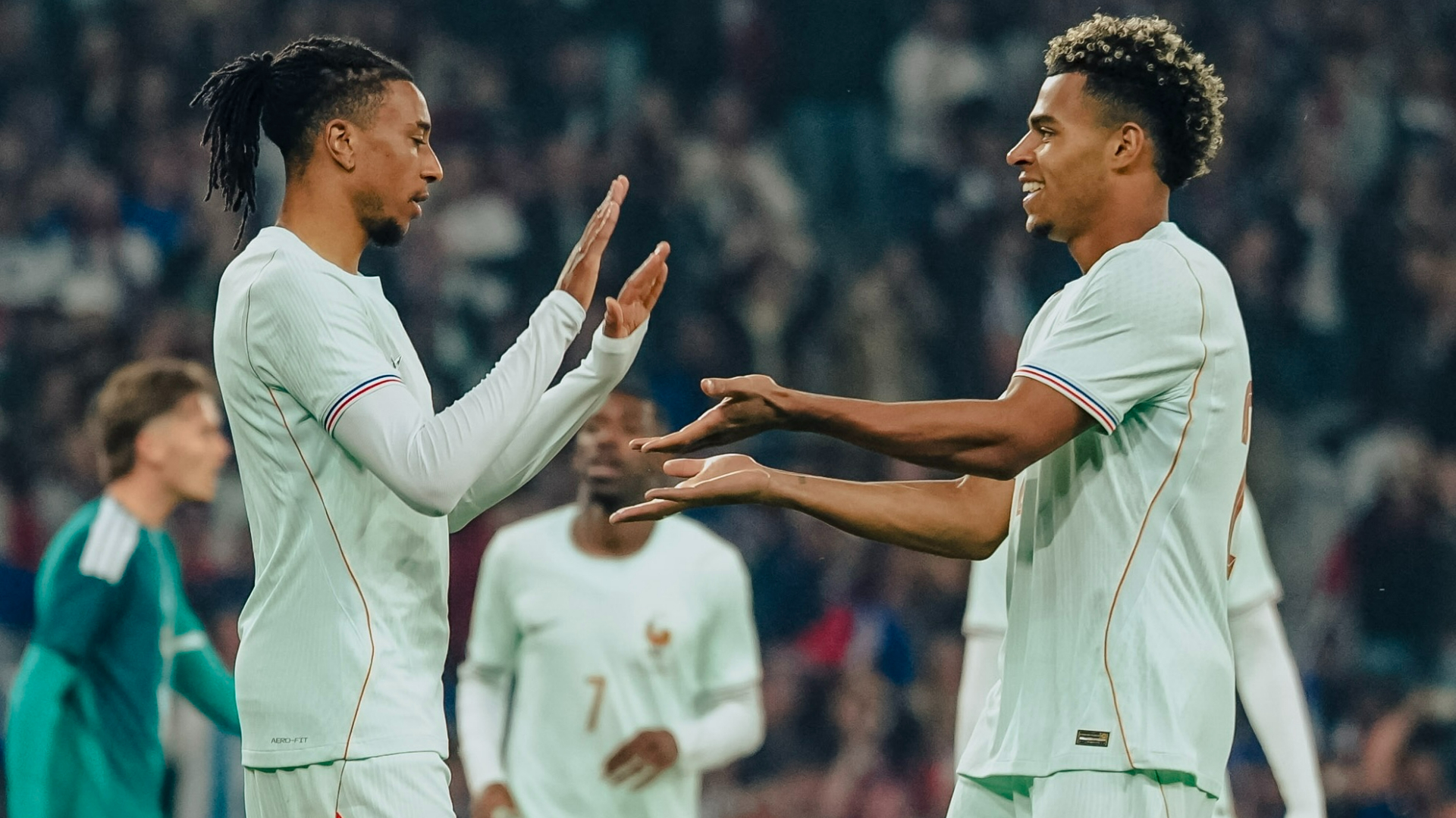 Michael Olise celebrates with Doue after a hat-trick in Northern Ireland friendly