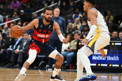 Washington Wizards guard Trae Young (3) dribbles as Golden State Warriors guard Will Richard (3) defends during the first half at Capital One Arena
