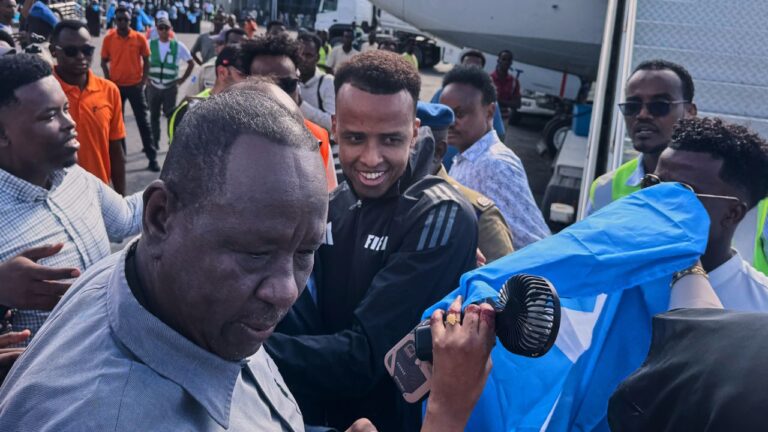 Referee Omar Artan, centre, who was denied entry to the United States, is welcomed by supporters upon his arrival in Mogadishu, Somalia, Wednesday, June 10, 2026.