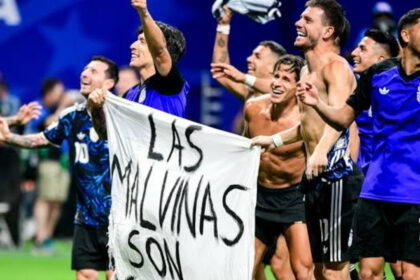 Argentina players celebrate with a banner reading ‘The Falkland Islands are Argentinian’
