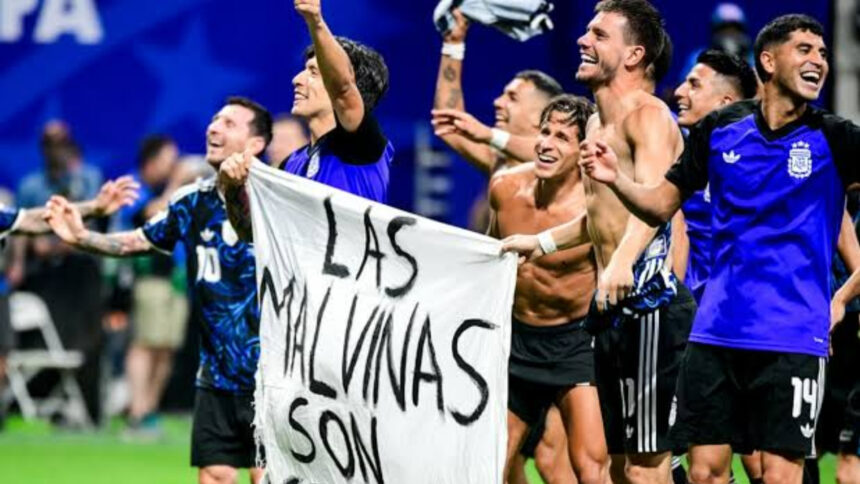 Argentina players celebrate with a banner reading ‘The Falkland Islands are Argentinian’