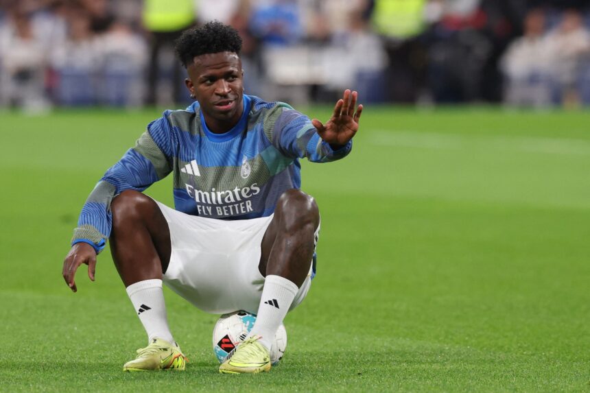 Vinicius Jr. sits on the ball during a warm up ahead of Valencia clash at the Bernabeu on Nov 1, 2025