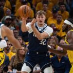 Dallas Mavericks forward Cooper Flagg (32) passes the ball while Indiana Pacers forward Jarace Walker (5) defends in the first half at Gainbridge Fieldhouse.