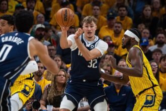 Dallas Mavericks forward Cooper Flagg (32) passes the ball while Indiana Pacers forward Jarace Walker (5) defends in the first half at Gainbridge Fieldhouse.
