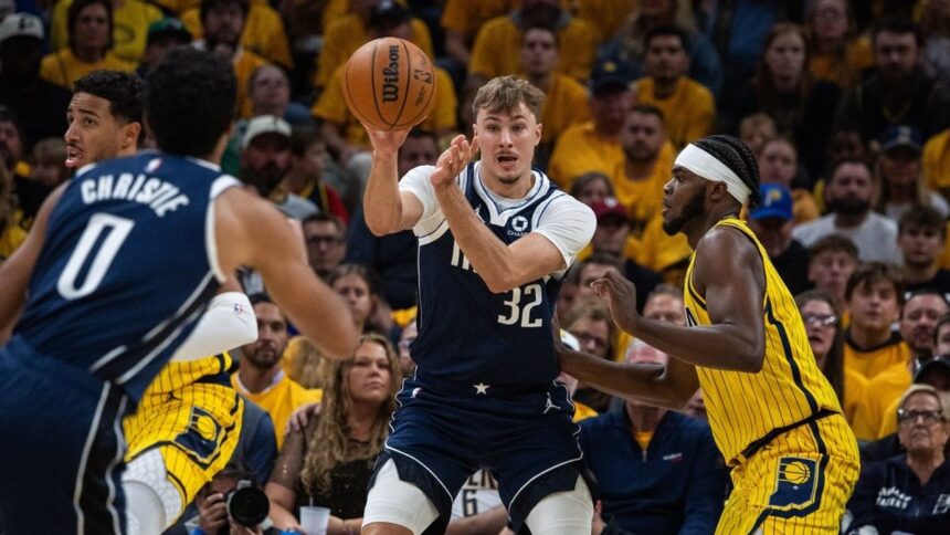 Dallas Mavericks forward Cooper Flagg (32) passes the ball while Indiana Pacers forward Jarace Walker (5) defends in the first half at Gainbridge Fieldhouse.