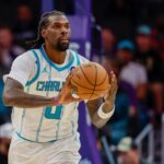 Charlotte Hornets center Naz Reid passes against the Washington Wizards during the first half of an NBA basketball game in Charlotte, N.C., Monday, Oct. 26, 2026. (AP Photo/Nell Redmond) (Nell Redmond/AP Photo/Nell Redmond)